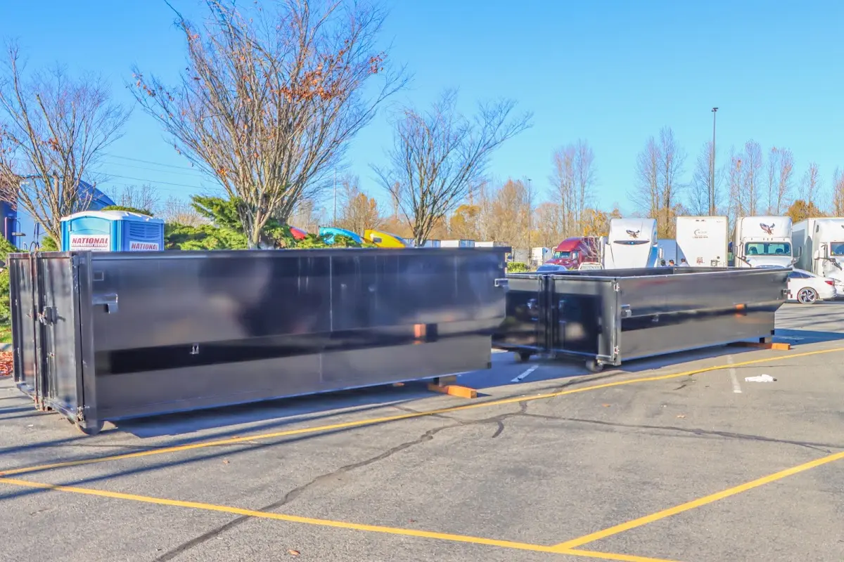 Professional dumpster rental service with roll-off container on residential driveway in Winter Beach